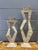A striking pair of vintage postmodern tessellated stone candlesticks, handcrafted in the Philippines with bold sculptural...