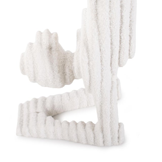 In textured white with ribbed detailing, these sculptures unique shape blend a touch of tranquility to any space....
