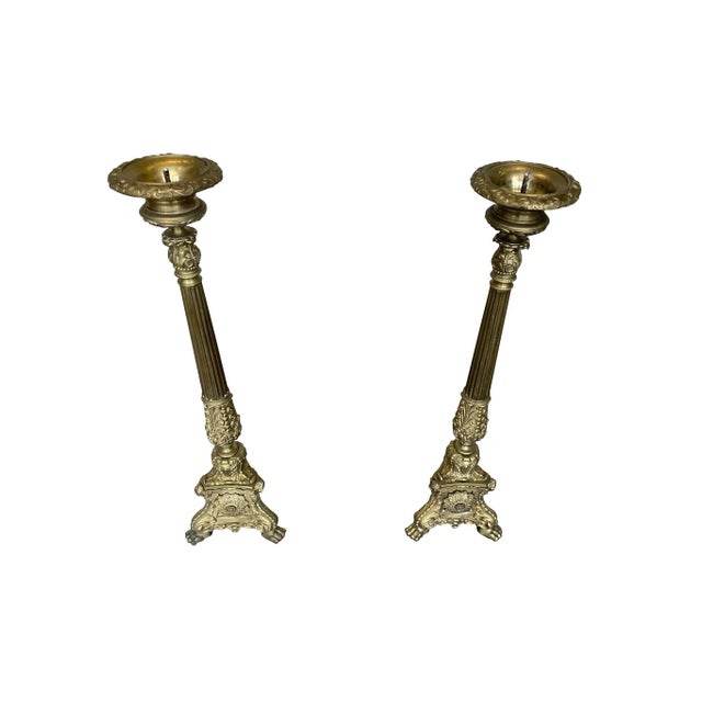 Lovely pair of large brass Altar Candlesticks. Adorned with classical embellishments, a pair of winged cherubs at the...
