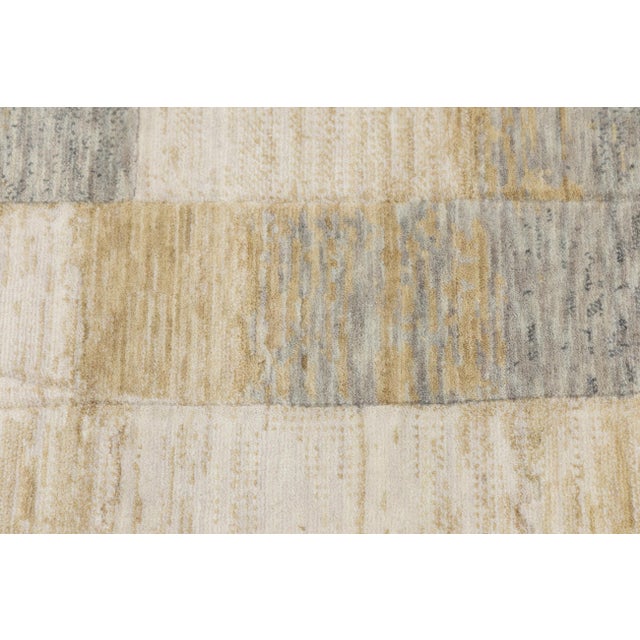 This sophisticated area rug features a contemporary geometric design with overlapping shapes and a textured finish, adding...