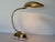 An elegant vintage table lamp featuring a beautifully sculpted brass mussel shell shade with finely textured detailing,...