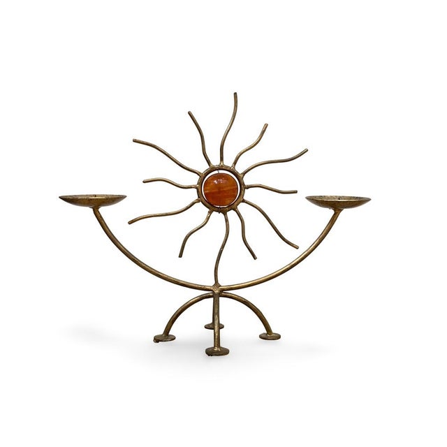 Two-light solar candlestick, circa 1960-1970 Made of patinated gilt metal, forming a stylized sun with sinuous rays...