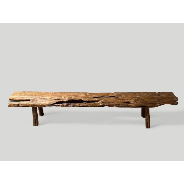 Impressive bench with beautiful character and patina hand made from a single four inch thick teak log. This bench was hand...