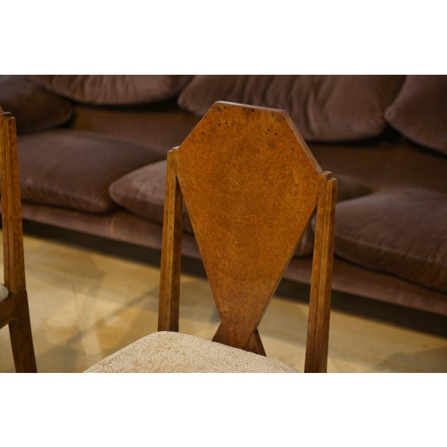 Pair of Art Deco style chairs, characterized by a solid back with a geometric silhouette. Baptistin Spade (1891–1969) was...