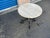 Kreiss iron decorative iron base with travertine top. Base is solid iron. Top is cream colored travertine. Table is in...