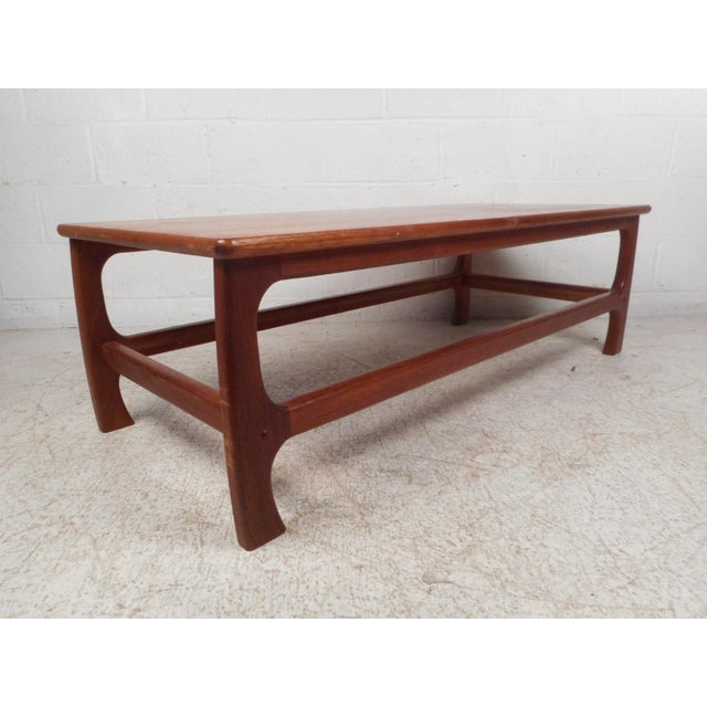 Stylish midcentury coffee table. Spacious table surface with interestingly contoured legs on the base. Great addition to...