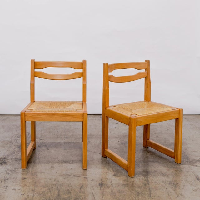 Brutalist set of six elm wood frame dining side chairs with rush seats by Maison Regain. France circa 1960's.