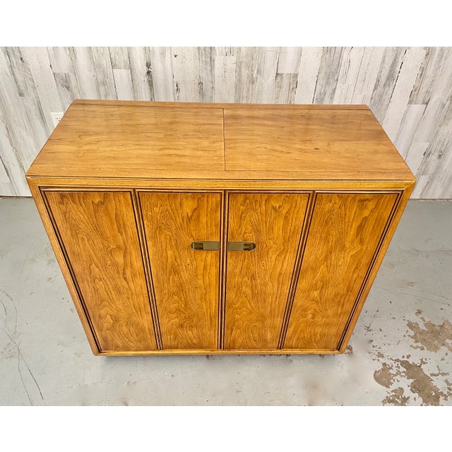 Drexel Extendable Top Liquor/Bar Cabinet with brass accents. This Piece has a nice finished back so it can easily be...