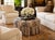 A substantial, fully upholstered cocktail ottoman featuring deep radial tufting and a tailored skirt, executed in a finely...
