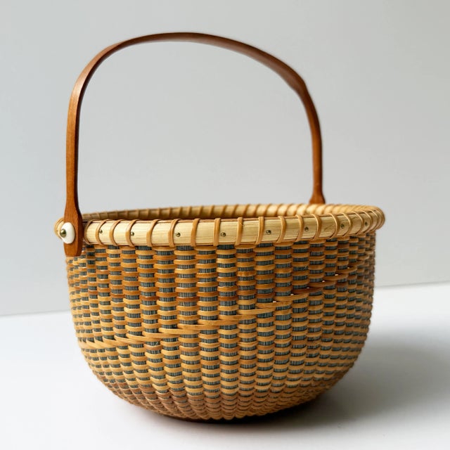 This beautifully handcrafted vintage Nantucket Lightship Basket is a signed piece, marked by the artisan on the underside....