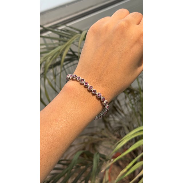 This 8.23 Ct Natural Pink Tourmaline Eternity Tennis Bracelet features a continuous row of round-cut gemstones in 925...