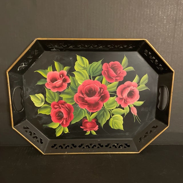 Wow, this piece is amazing. It's black with stunning pink roses and green leaves. It also has gold paint around the rim...