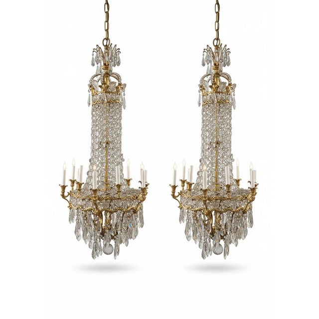 Circa 1900 Caldwell pair of unique and impressive crystals and gilt bronze chandeliers with flowers design. One chandelier...