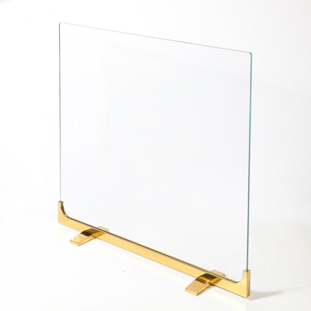 This striking Mid-Century Sculptural Polished Brass &amp; Glass Fireplace Screen originated in the United States, 20th...