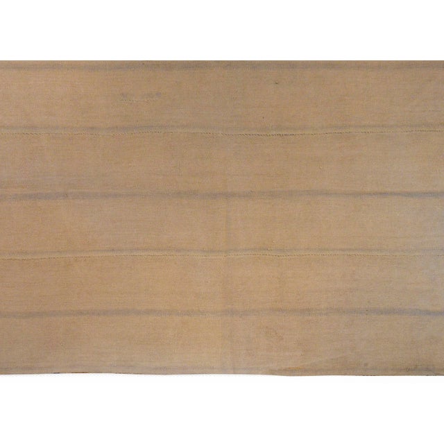 A wonderful vintage Turkish cotton kilim rug constructed of three panels stitched together with a striped pattern woven in...