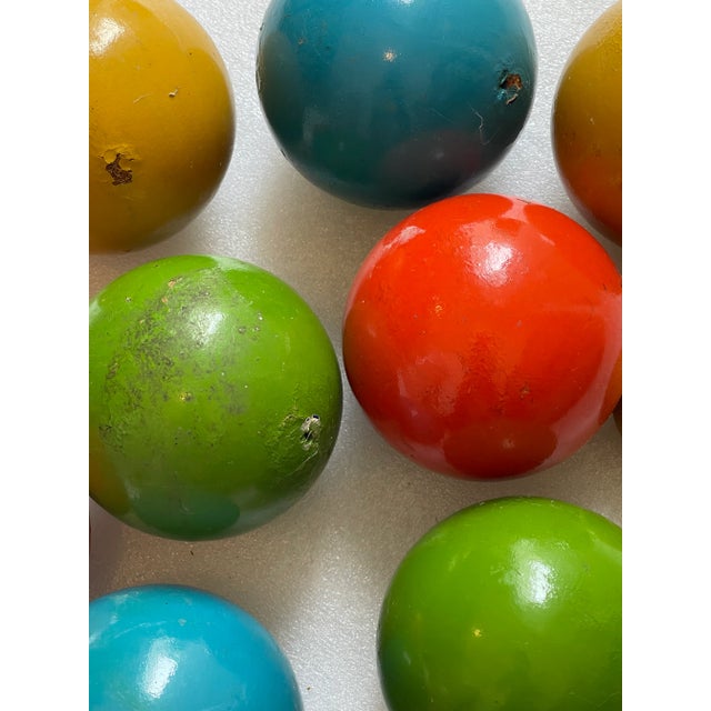 12 Pcs Vintage enamelled polychrome on wood balls. 4” diameter. Carpet balls or garden balls. Great colourful decoration.