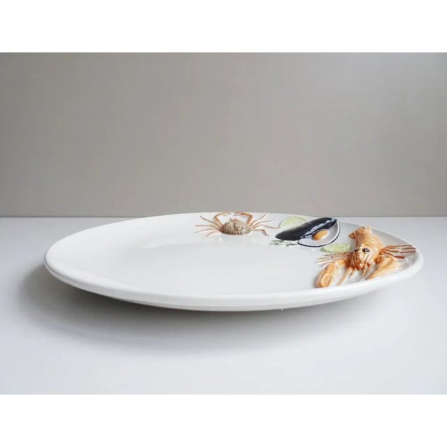 This large fish plate is a round serving plate from the 1970s. Handmade and hand -painted Bassano ceramics from Italy. The...