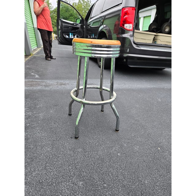 A pair of vintage countertop stools with chrome base and legs. Stools took are hardwood with a light oak finish. The...