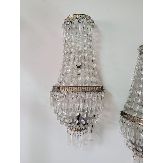 Pair of brass wall lights with Louis XVI glass decorations Refined pair of wall lamps with a typical balloon shape; the...