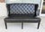 This Arhaus black tufted leather settee features a classic design with deep button tufting, wingback sides, and elegant...