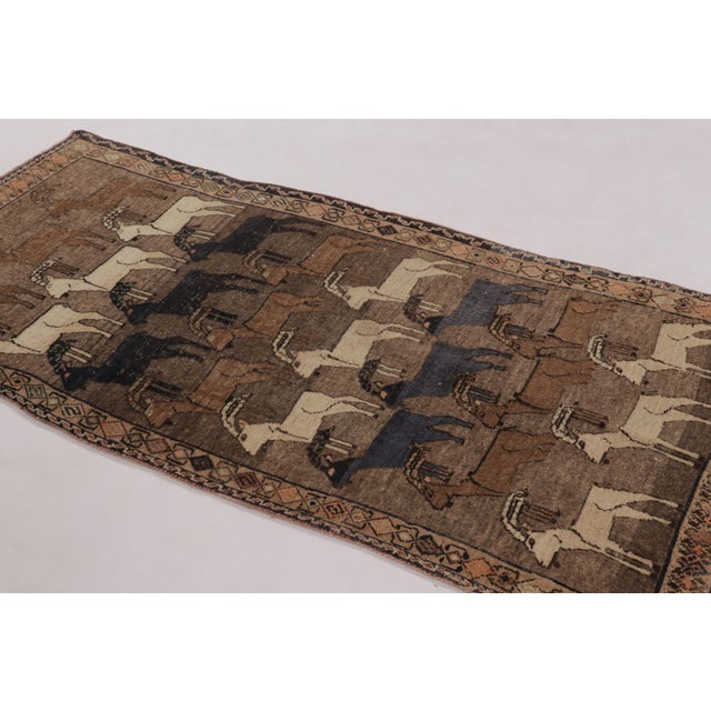 Hand-knotted in wool circa 1950-1960, this 3x7 vintage Persian Gabbeh runner is a charming entry in Rug & Kilim’s curation...