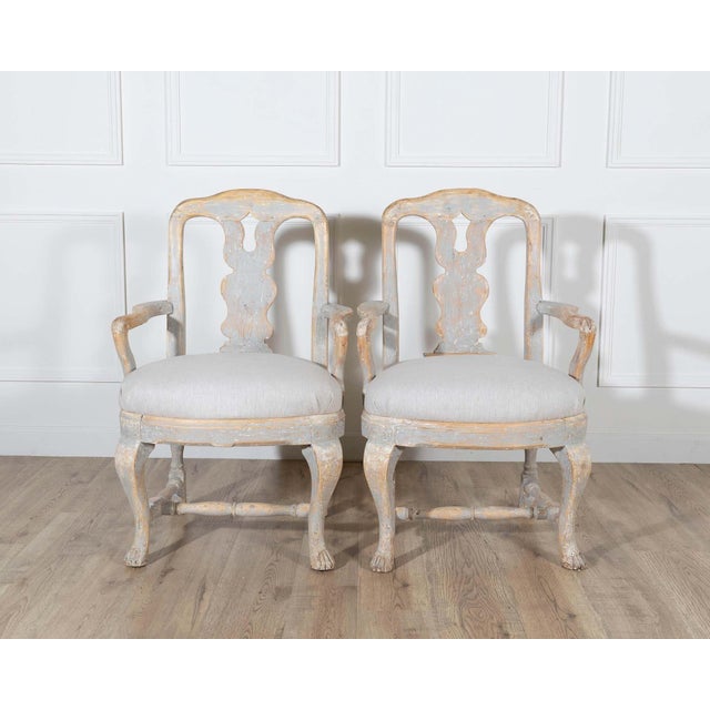 This graceful pair of Swedish Rococo armchairs embodies the refined curves and expressive craftsmanship of 18th-century...