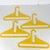 Incredible lot of four hard plastic yellow vintage clothes hangers in the style of Danilo Silvestrin. Vibrant color....