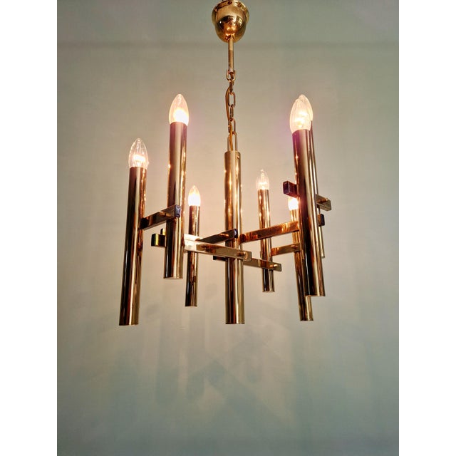 Geometric brass chandelier, 8 lights, Hollywood Regency style, based on a design by Gaetano Sciolari, produced by the...