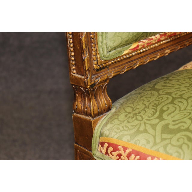 An exceptionally decorative French Louis XV-style armchair, made in France and beautifully crafted from carved walnut with...