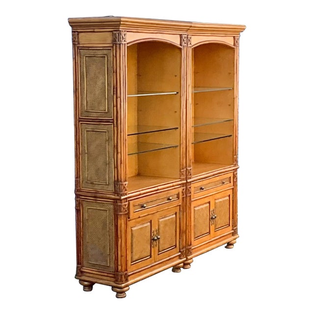 This is a set of regency style carved fruitwood faux bamboo style cabinets. They are able to be lit, and the glass shelves...