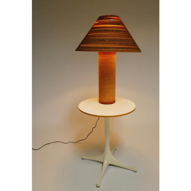 The cardboard lamp and lamp shade designed by Gregory Van Pelt are exemplary pieces of sustainable and innovative design,...