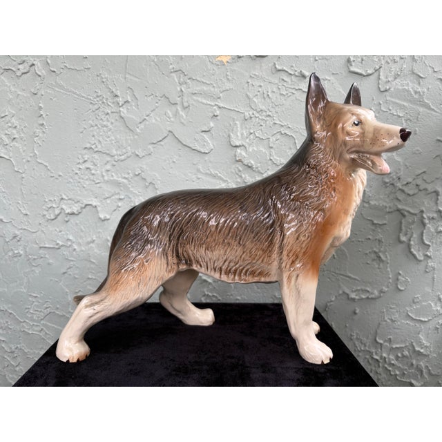 This striking vintage porcelain figurine depicts a German Shepherd (Alsatian) in an alert standing pose, finely modeled...
