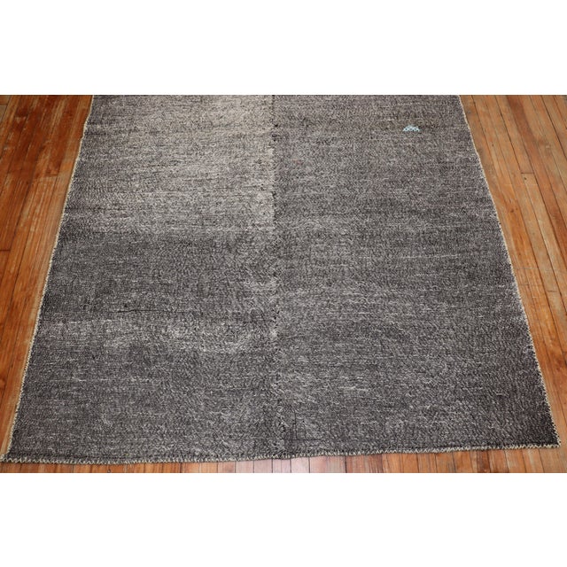 Midcentury Kilim with Minimalist plain design with an overall charcoal shade, small motifs spotted in light blue too...