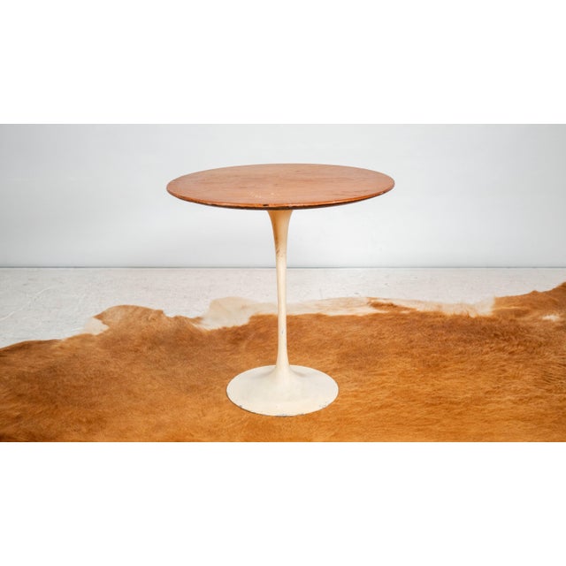 Vintage Eero Saarinen for Knoll International tulip side table with walnut veneer top and white base, circa 1970s. From...