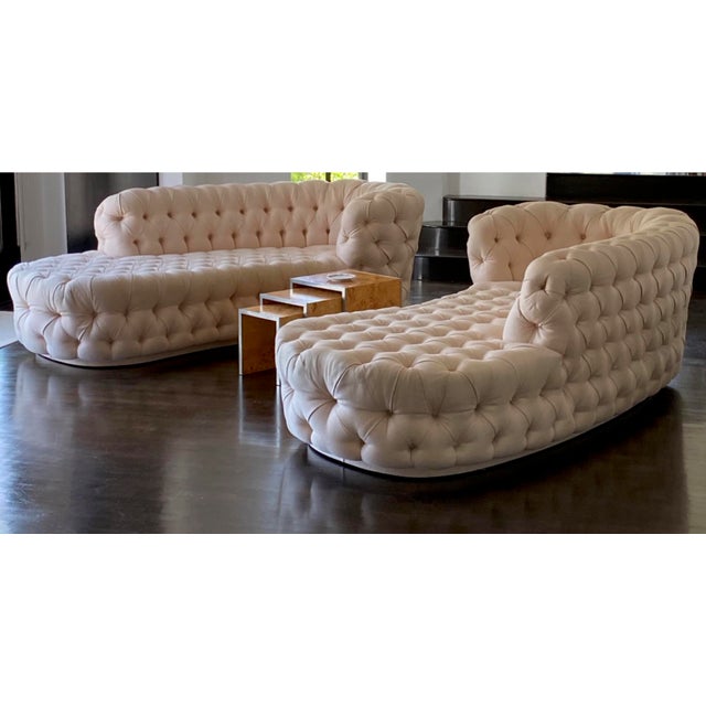 A stunning matching pair of deep button-tufted curved settees in a soft blush pink cotton damask blend — a true "his &...