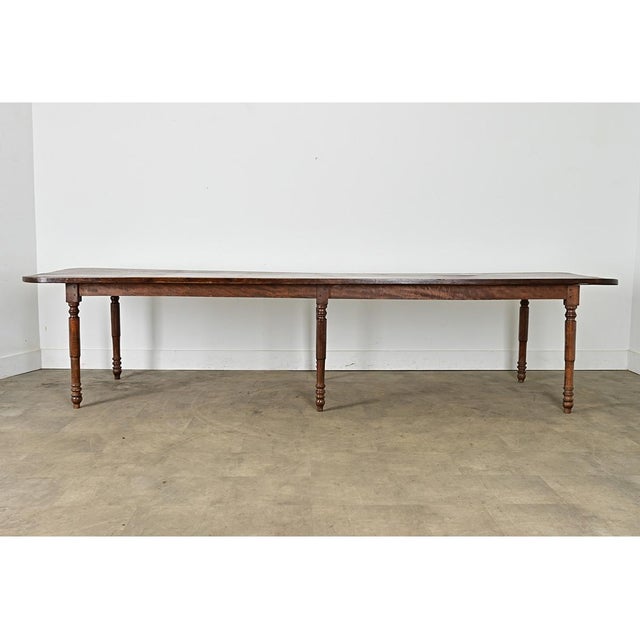An outstanding country farmhouse table from 19th century France, handcrafted from solid oak and aged to a black walnut...