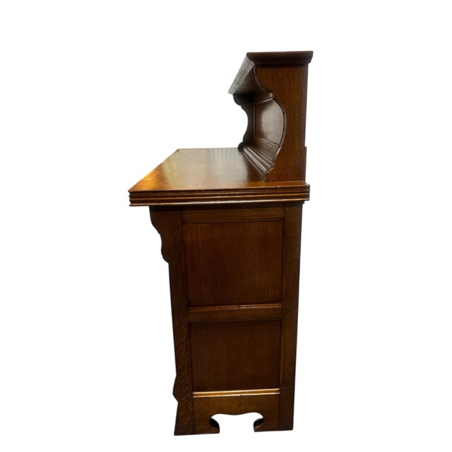 The Vintage Carved Oak Sideboard Server Bar Cabinet is a traditional piece of furniture handmade in the United States. It...