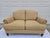 A beautiful tan and beige rolled arm loveseat with down filled cushions. This piece features a tweed fabric and sculpted...