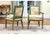 A very fine pair of antique armchairs with classic Louis XVI form. The frames are painted teal-green with parcel gilt...