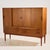 Danish teak highboard with unique handles from the 1960s. This teak beauty has plenty of storage space with four sliding...