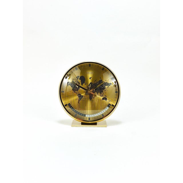 A beautiful and decorative Mid-Century Modernist solid brass Kienzle Chronoquartz desk or table clock with a domed glass...
