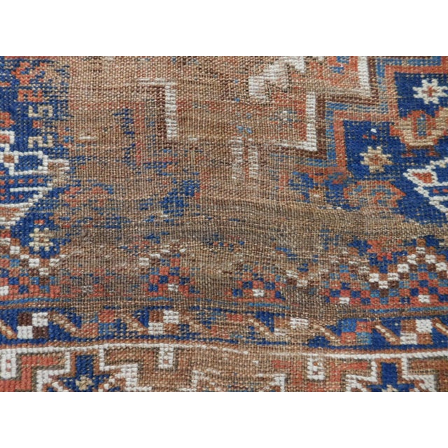Circa 1900 Distressed antique Persian tribal rug. Wool pile on wool foundation. Triple medallion in geometric shape, on...
