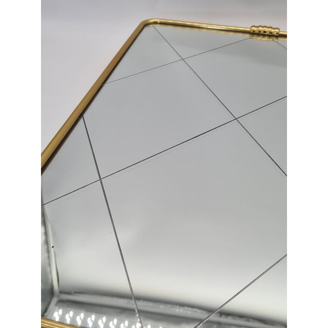 An elegant, unique wall mirror in the Italian Mid-Century Modern style, dating from the 1950s and 1960s.The mirror...