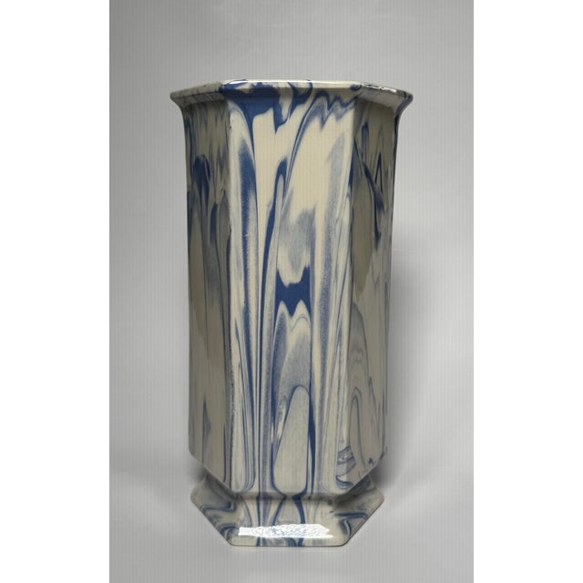 The vase features a distinctive blue and white marbleized (or "slag") glaze pattern on a hexagonal 6-sided body with a...