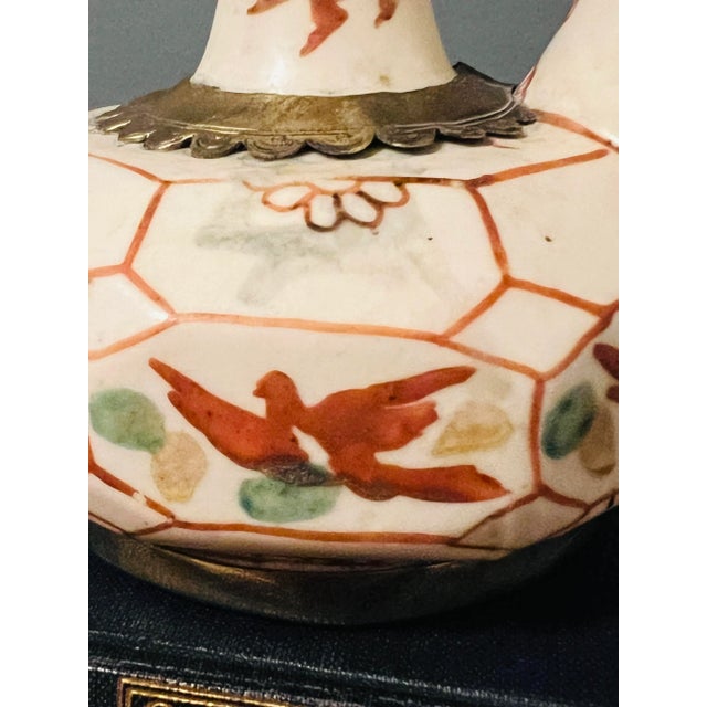 Antique Japanese drinking vessel/ Kendi . It’s a beautiful hand painted old piece with brass design. Stamped. Has many...