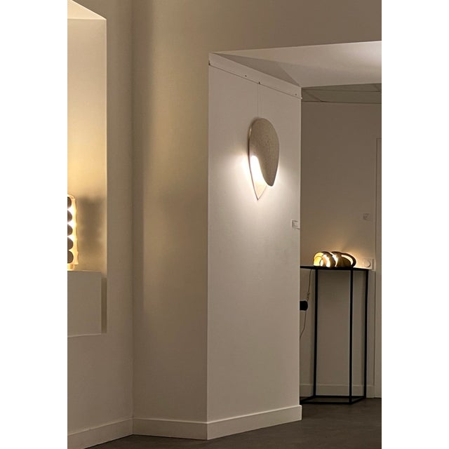 This ceramic wall light is crafted from durable stoneware, designed specifically for exterior spaces. Its minimalist yet...