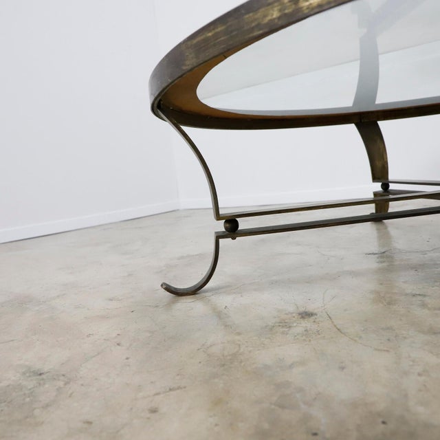 Made in Mexico, circa 1950s, designed by Arturo Pani, the table has original mirror glass and solid brass base.