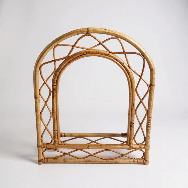 This French rattan wall mirror features a mid century vintage arch design with a woven frame, crafted to bring a stylish...