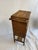This is an antique woven rattan sewing stand, a tall, narrow work table with a hinged lift-lid top compartment and two...