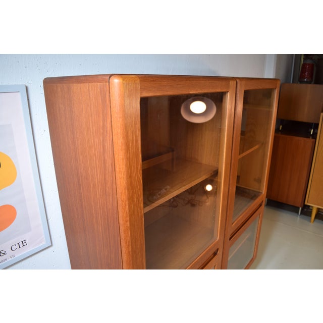 This is a two-door vintage display cabinet from the Danish manufacturer Kollund Möbler. The cabinet was made in Denmark in...